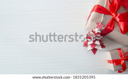 holiday gifts with wooden tree on wood background