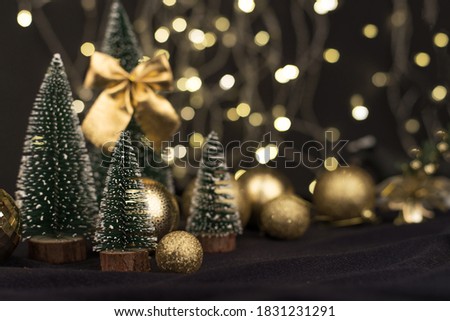 Beautiful dark Christmas composition, decorative Christmas trees, balloons, bokeh lights. New year 2021
