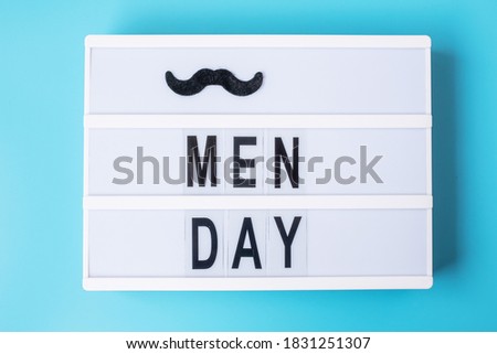 Men day text with mustache on lightbox. International Men day and Father day concept