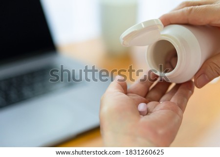 close up picture of senior woman taking medication and drink water aafterward. healthcare and medical concept