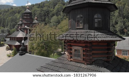 Orthodox church in the west ukrainee. Wooden windows and black roof tiles. Scenery of summer nature.