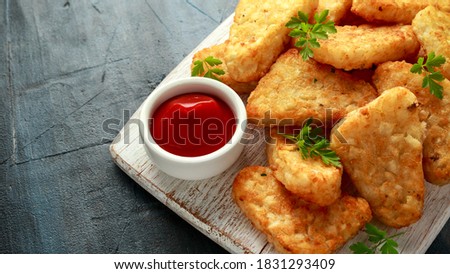 Hash brown potato with ketchup on white wooden board Royalty-Free Stock Photo #1831293409