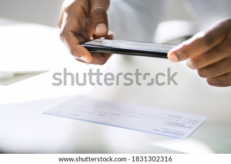 Remote Check Deposit Using Mobile Photo Scanning Royalty-Free Stock Photo #1831302316