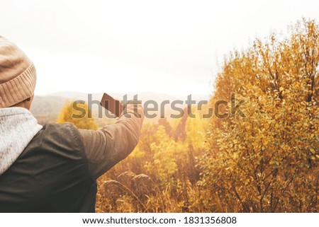 Tourist takes pictures of nature on phone