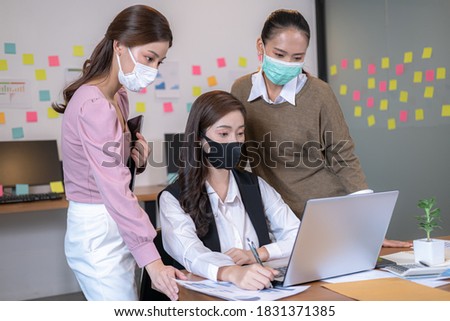 Business consulting in office agency with face mask according to Covid-19 and coronavirus pandemic
