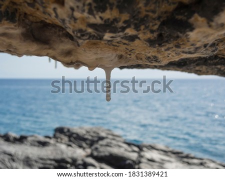 Small limestone stalactite with sea at the horizon from Marina di Camerota beach