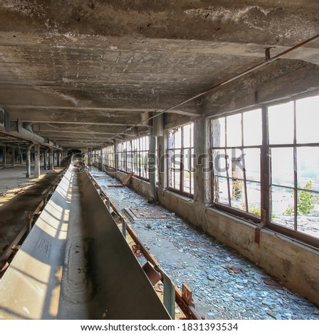 Conveyor in abandoned factory used to process and store grains