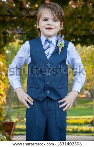 ring bearer young boy outside Royalty-Free Stock Photo #1831402306