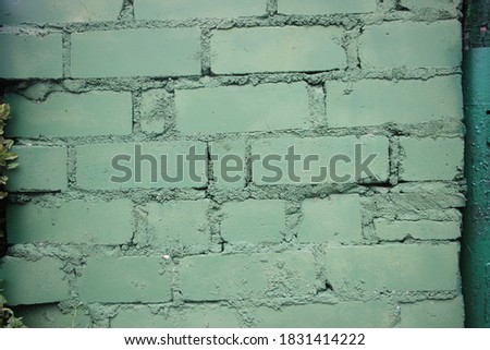 Painted into military green Brick wall background closeup.