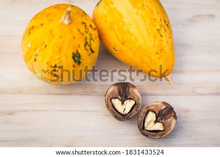 Walnuts and pumkins on the wood texture