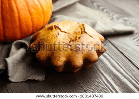 Homemade pumpkin loaf cake on dark wooden background. Autumn pumpkin pastry for Thanksgiving