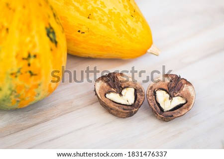 Walnuts and pumkins on the wood texture