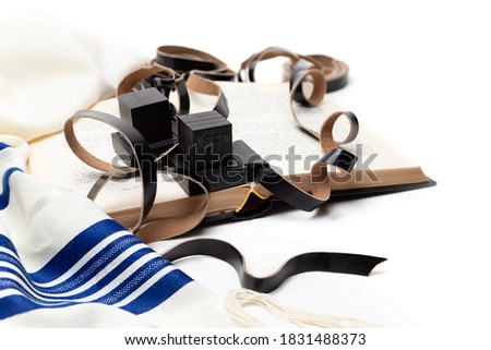 Tallith and tefillin and book on white background Royalty-Free Stock Photo #1831488373