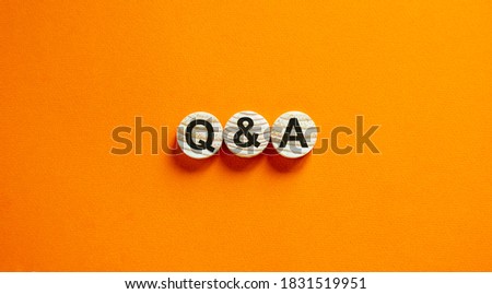 Concept text 'Q and A' on wooden circles on a beautiful orange  background. Business concept. Copy space. Royalty-Free Stock Photo #1831519951