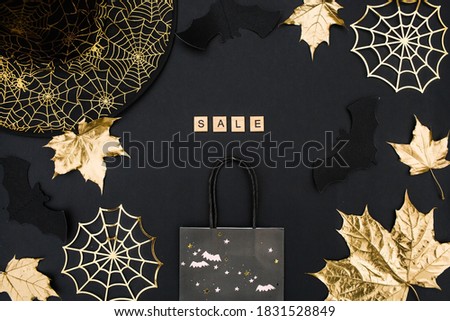 Modern background with bats, Golden leaves and cobwebs.The inscription in English: "sale".Halloween online shopping. Holiday sales, seasonal sales, Black Friday, discounts, and shopping on site