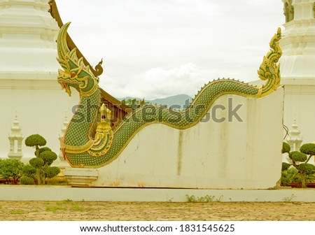 Serpent statue on natural landscape background