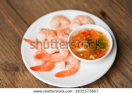 Shrimp delicious seasoning spices on white plate appetizing cooked boiled shrimps prawns , salad shelfish seafood sauce