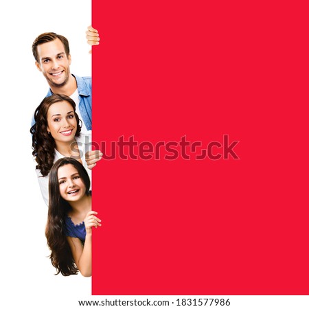 Family portrait image - happy smiling father, mother and little daughter peek out from behind blank red color sign board, isolated over white background. Empty paper broadsheet with ad copyspace area.