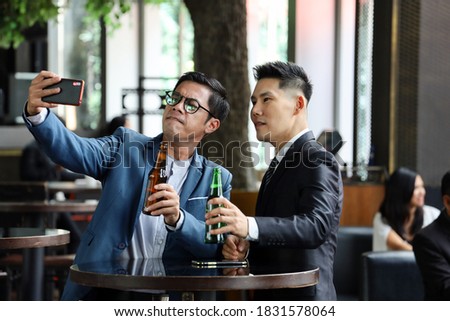 Executive business people greeting and meeting with partner or customers, alcohol drink hang out and smile talking and take picture together after work
