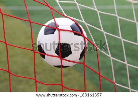 soccer football in goal net