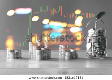 silver coin stack business money back and white, light and graph background
