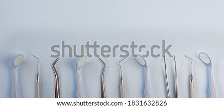 Dentist tools. Teethcare, dental health concept. Blue background top view copy space. High quality photo
