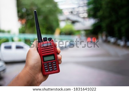 Security guard uses radio communication for facilitate traffic. Traffic Officers use walkie talkie to maintain order in the parking lot in Thailand.