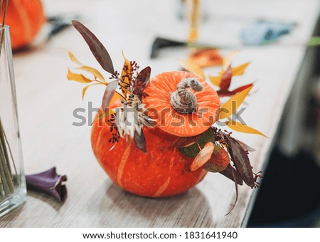 DIY autumn flower arrangement bouquet in pumpkin at floristry studio