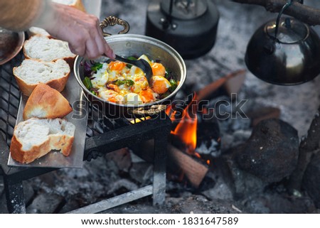 Fried egg in a camping pan on camping fire Royalty-Free Stock Photo #1831647589