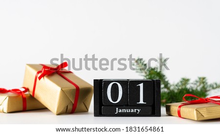 January 1st. Day 1 of january month, calendar with gift boxes and fir branches on white background. Winter time. Happy New year concept. New start. Copy space for text