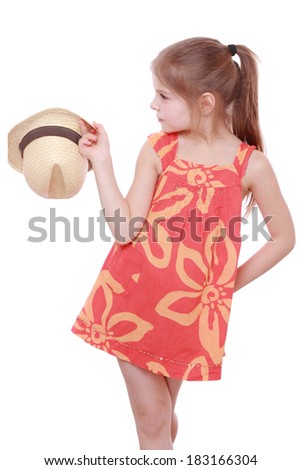 Smiley beautiful little girl wearing summer dress and hat