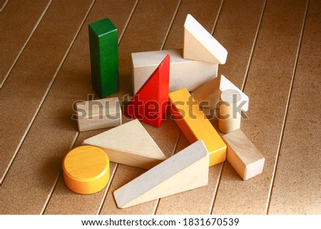 some pieces of building blocks on the wooden floor 
