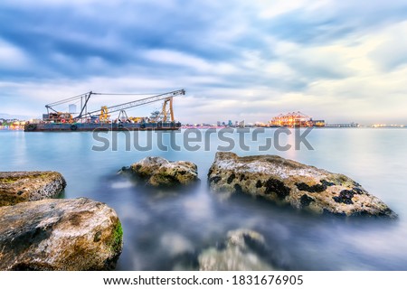 Long exposure landscape of port of Mersin. The Port of Mersin (Turkish: Mersin Limani), is a major seaport located on the north-eastern coast of Mediterranean Sea in Mersin, southern Turkey.