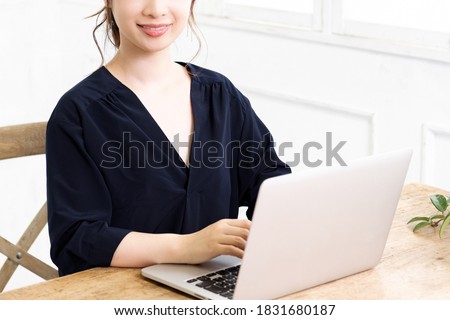 A young woman using a laptop shot in the studio