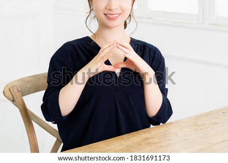 A young woman making an OK gesture shot in the studio