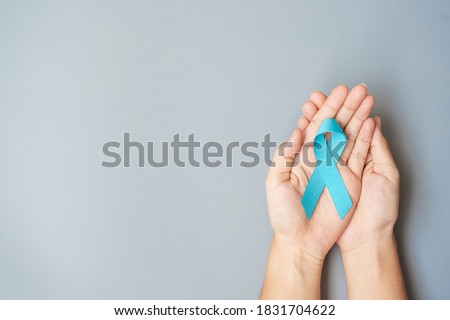 November Prostate Cancer Awareness month, Man holding light Blue Ribbon for supporting people living and illness. Healthcare, International men, Father, World cancer day and world diabetes day concept