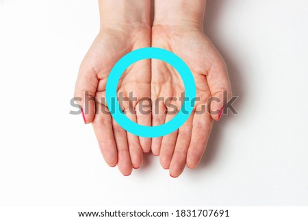 Blue circle on female hands on white background, concept of diabetes.