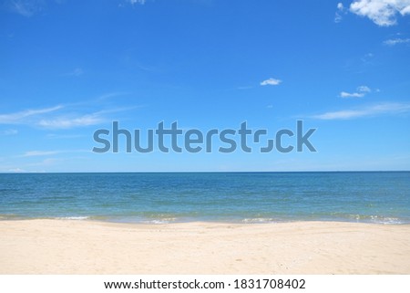 Beautiful white clouds on blue sky over calm sea with sunlight reflection,Sea view from tropical beach with sunny sky. Summer paradise beach 