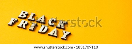 Wooden letters text BLACK FRIDAY in front yellow background, copy space, banner Top view Flat lay seasonal sale, retail, shopping concept
