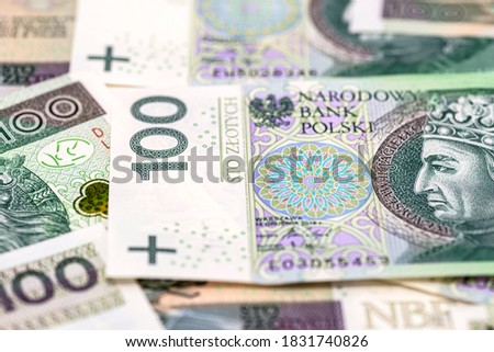 Macro photo of the front side of a Polish 100 PLN banknote, close-up on the inscriptions.