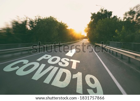 The empty road in the forest and the text on the asphalt "Post covid19". Royalty-Free Stock Photo #1831757866