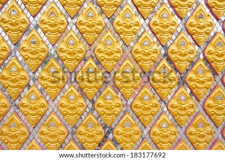 Thai pattern on Thai temple, golden flower pattern on white glass wall