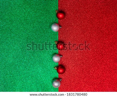 Christmas composition. Red and silver Christmas balls on a red and green background. Flat lay, copy space, top view, new year.
