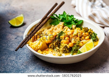 Vegan chickpea curry with cauliflower, broccoli, kale and quinoa. Healthy vegetarian food concept. Royalty-Free Stock Photo #1831782025