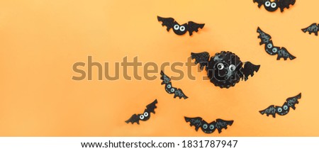 Model of Covid virus in the shape of a bat with flying bats in the background. Scariest hero in Halloween 2020. Halloween during Corona virus global pandemic concept. Wide banner. Copy space