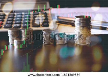 silver coin stack business money, light and graph background
