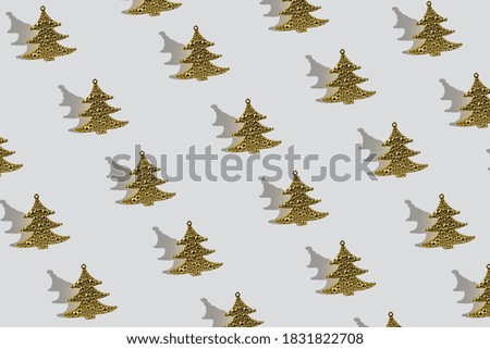 pattern of Golden toy Christmas tree on white background with shadow, Christmas background, new year's composition