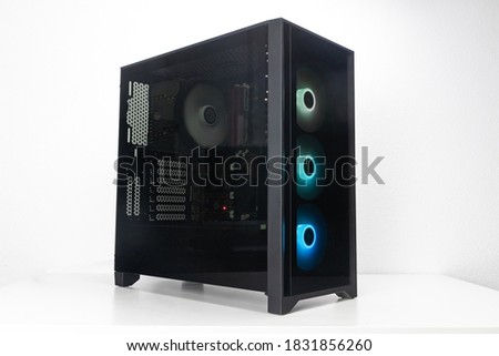 Gaming PC with RGB LED lights and big fans on the front. Computer assembled with hardware components Royalty-Free Stock Photo #1831856260