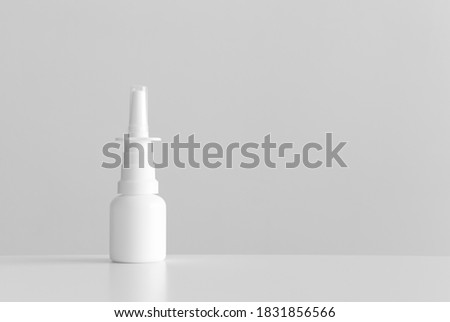 White nose spray bottle mockup with blank copy space on a white table.