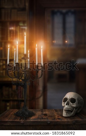 Halloween scenery in old castle, candelabrum with skull